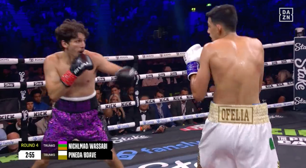 A boxing match between a white man with short brown hair and purple shorts, and a Mexican man with white shorts.