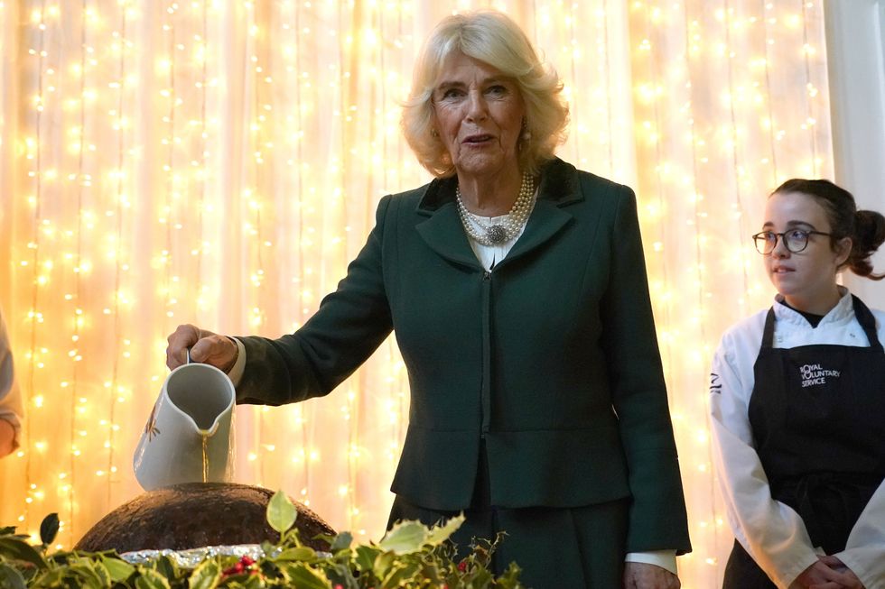 ‘Hold on to your hair’: Camilla helps light Christmas pudding at charity lunch