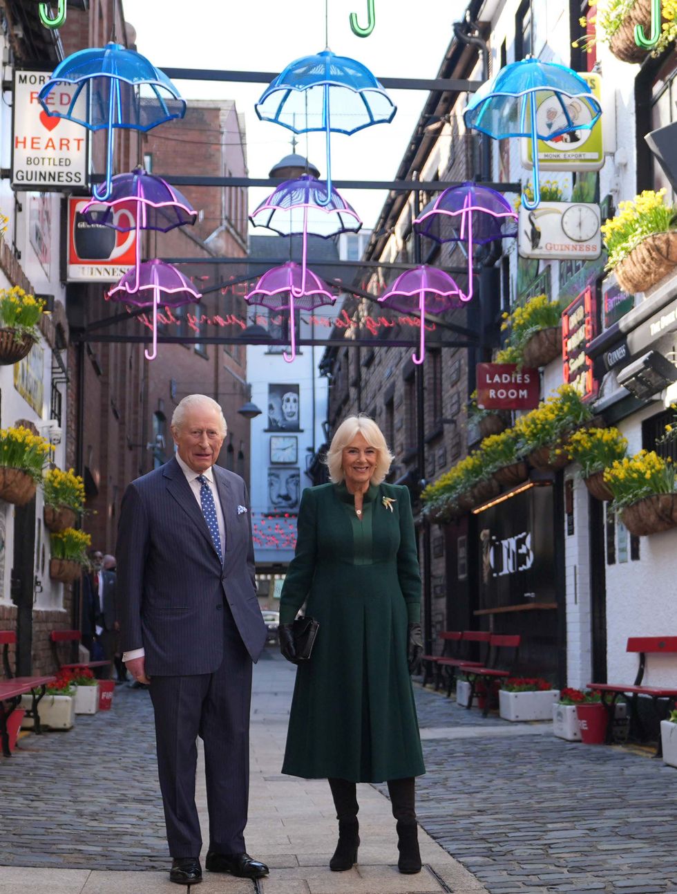 Charles and Camilla commence NI visit with sea shanties and acrobatics