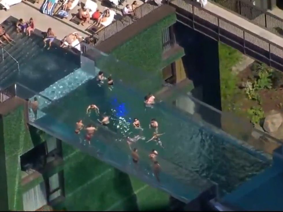 A transparent swimming pool more than 100ft above the ground is making  people feel sick