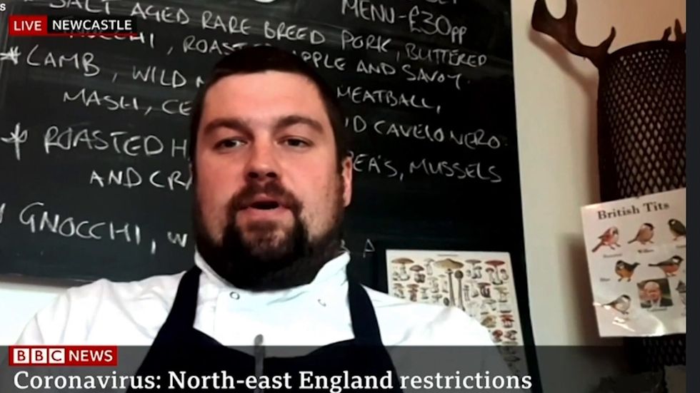 Chef trolls Boris Johnson with poster in the background of a TV interview