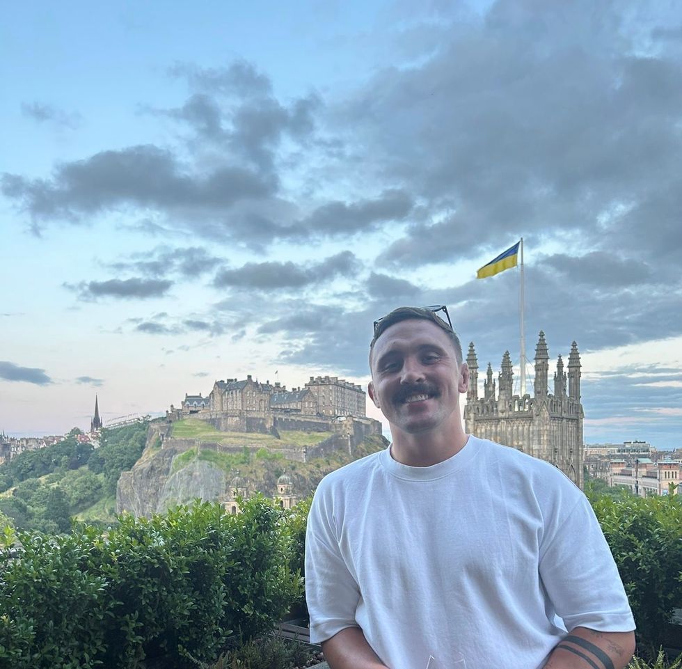 Man stood outside with Edinburgh castle behind him