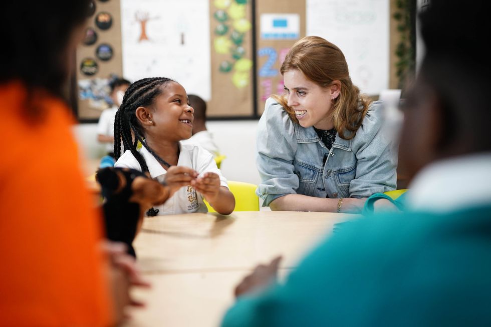 Princess Beatrice praises her mother on school visit to read prize-winning book