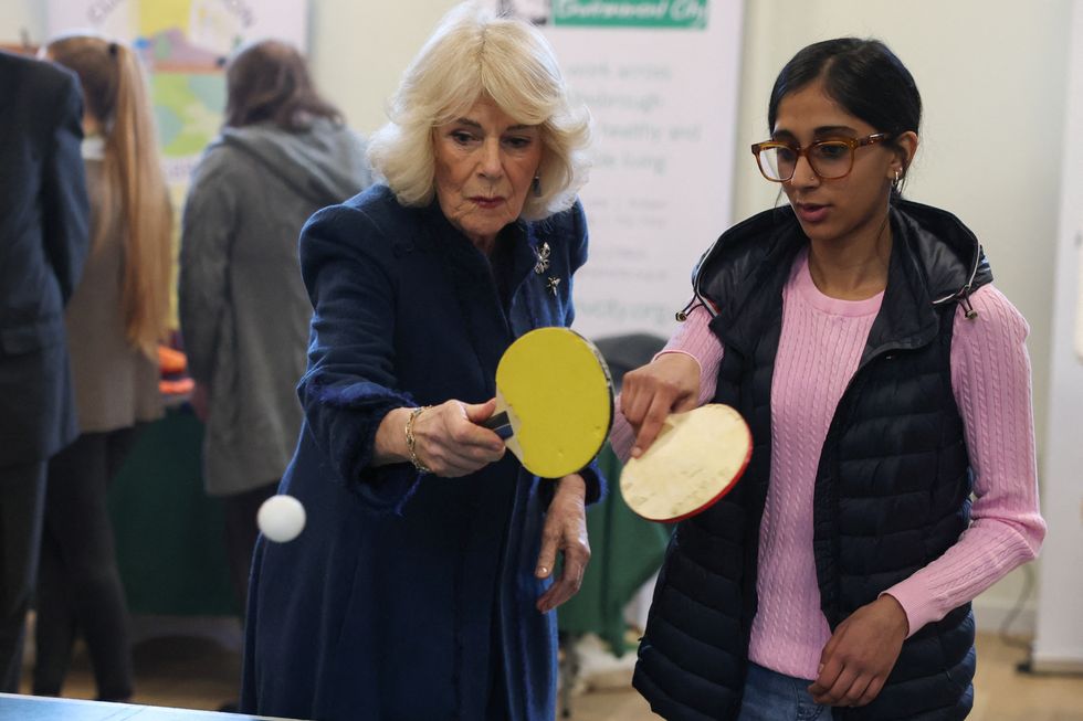 Queen shows off table tennis skills as King rues end to his skiing days