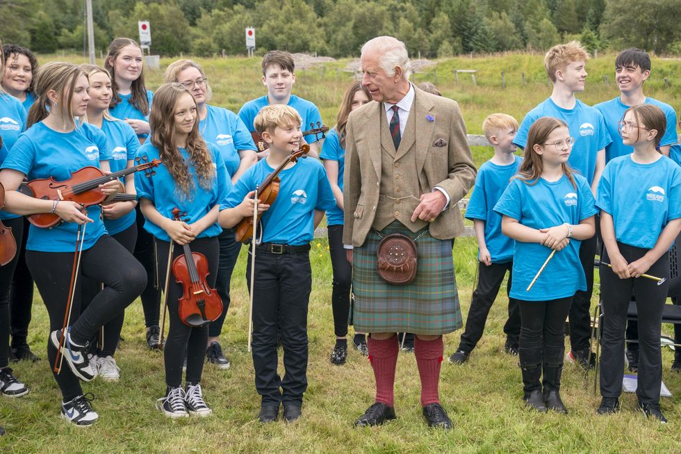 King battles midges on visit to Highland peat bog declared world heritage site