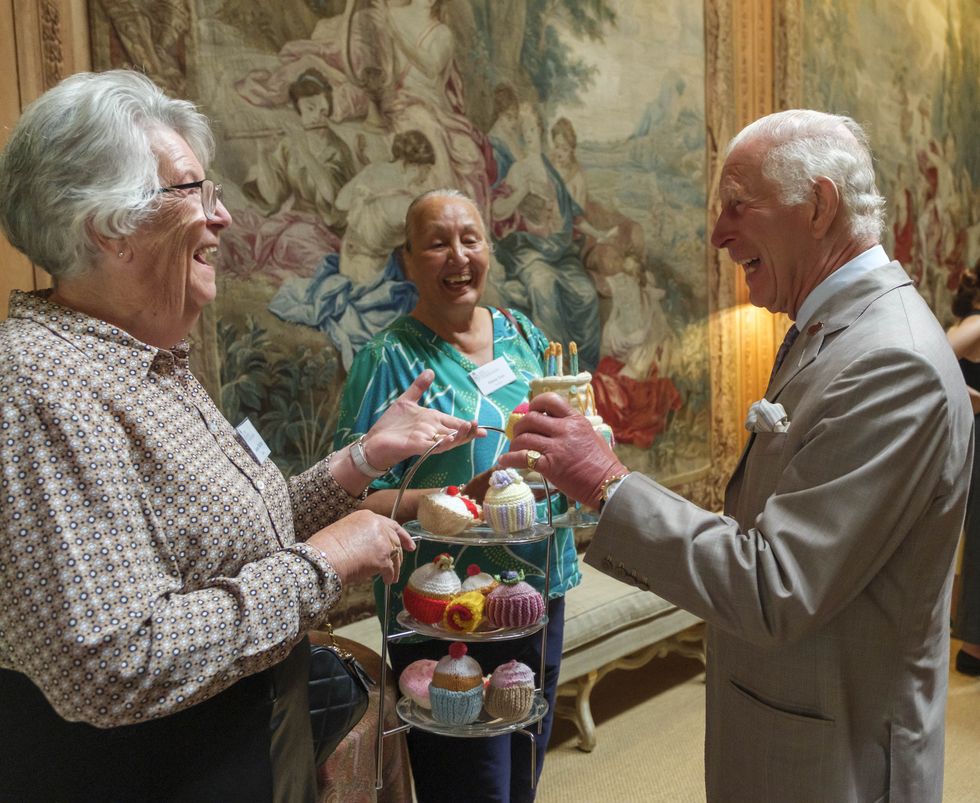 King receives knitted cake to mark 10 years of textiles skills drive